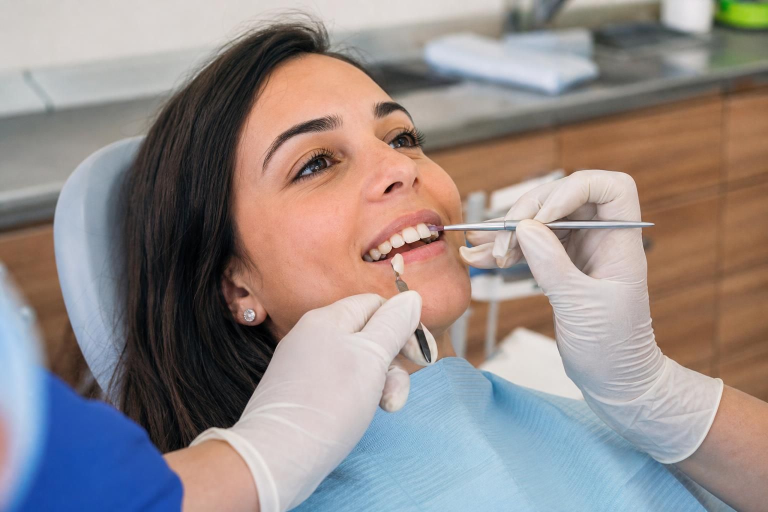Dentist applies bonding material to front teeth